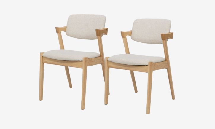 Angled view of Atlas Dining Chair made of rubber wood upholstered with cream fabric