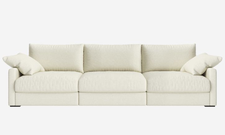A warm white fabric, three-seater sofa with plush cushions and a modern, minimalist design.