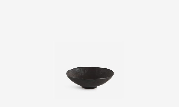 Small, dark, ceramic bowl with slightly irregular edges.