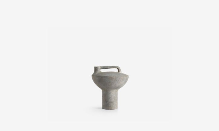 Minimalist, textured, modern ceramic vase with a cylindrical body and a small handle on top