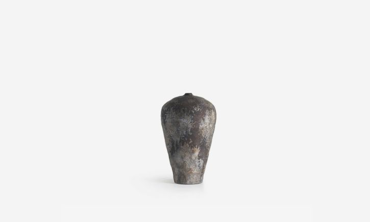A classic-shaped ceramic vase with a vivid surface and rustic colours.