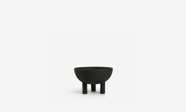 A black scandinavian-inspired three-legged bowl, perfect for decorative or functional piece.