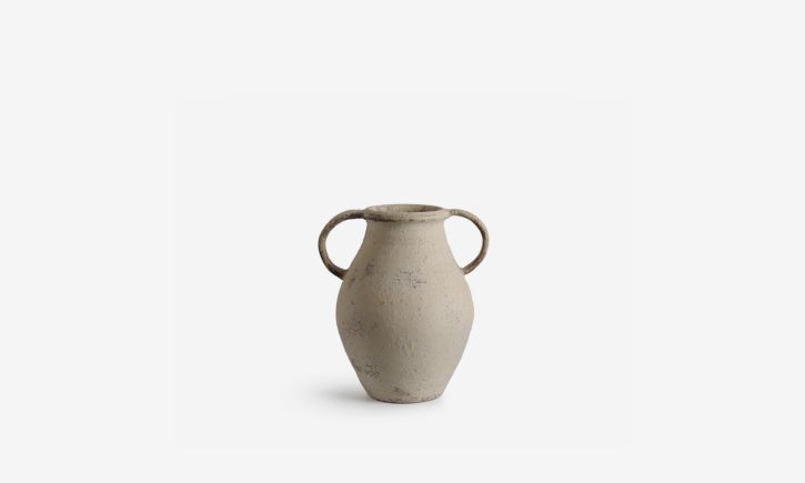 A beige ceramic vase with a rough texture, featuring two looped handles on either side.