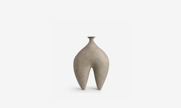 Sculptural vase with a narrow neck and two curved leg-like extensions, resembling a minimalist abstract figure.