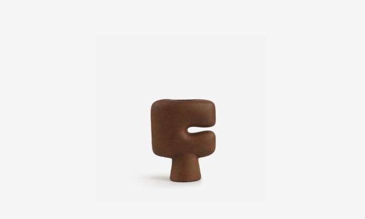A textured brown ceramic vase with an abstract, sculptural form.