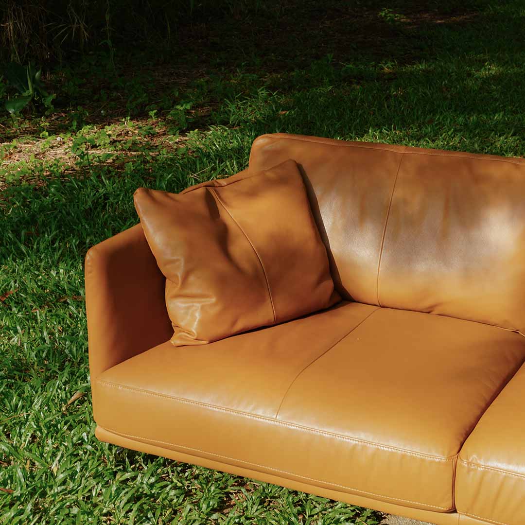 Close up lifestyle photo of Portage 3 Seater Sofa in Vedura Tan Leather in forest